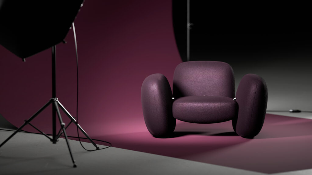 A modern, rounded armchair upholstered in purple fabric is displayed on a matching purple backdrop in a photography studio with studio lights visible.
